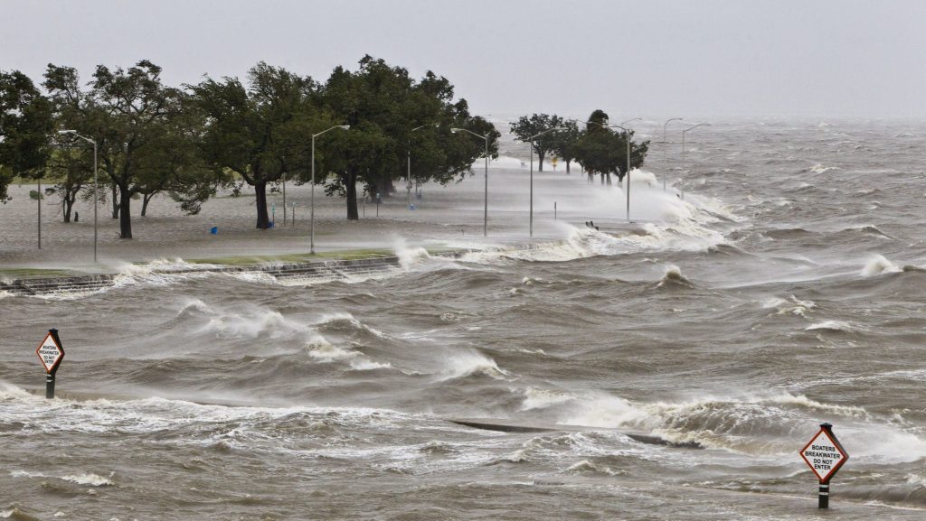 During Hurricane Isaac, a storm surge causes tides to quickly rise while rough waves pound the concrete seawall along the shores of Lake Pontchartrain. 